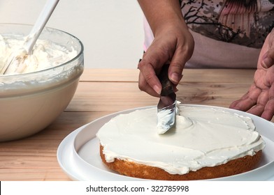 Putting Butter  Cream Cake By Hand Using Spatula