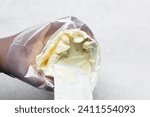 Putting Buttercream into a piping bag, American buttercream in a piping bag for icing cake, frosting for decorating cake