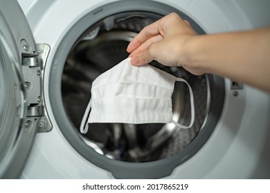 Putting Cloth Face Mask Into The Washing Machine