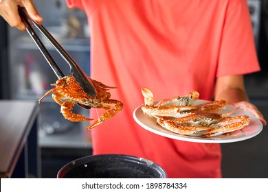 Putting Cooked Blue Crab On White Plate.