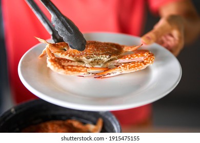 Putting Cooked Blue Crab On White Plate.