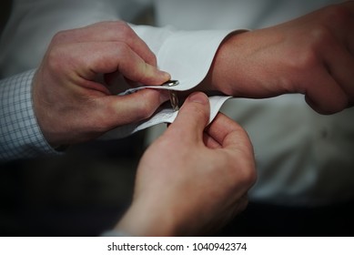 Putting Cuff Links On.