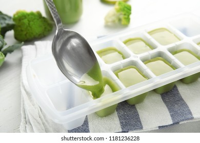 Putting Healthy Baby Food Into Ice Cube Tray, Closeup