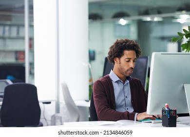 Putting in the hours to get work done. Shot of a young businessman sitting at a desk. - Shutterstock ID 2134846059