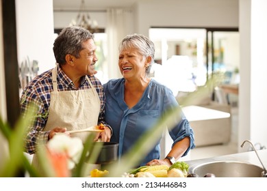 Putting A Lot Of Love Into Their Meal. Shot Of A Happy Senior Couple Cooking A Healthy Meal Together At Home.