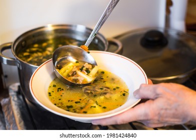 Putting Mushroom Soup With Ladle In Plate