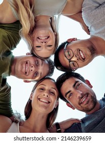 Putting Our Heads Together. Low Angle Portrait Of A Young Group Of Friends Standing Outside In A Huddle.