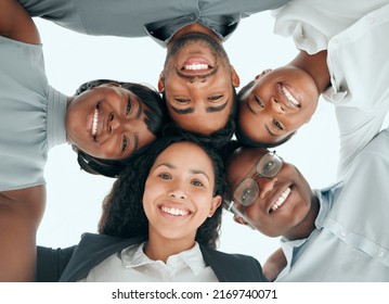 Putting Our Heads Together. Low Angle Portrait Of A Diverse Group Of Young Businesspeople Standing In A Huddle In The Office.