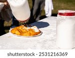 Putting powder sugar on fried dough at Seaside festival 