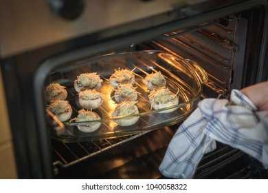 Putting Stuffed Mushrooms With Blue Cheese In The Oven