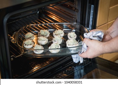 Putting Stuffed Mushrooms With Blue Cheese In The Oven