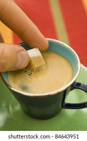 Putting A Sugar Cube In A Cup Of Coffee