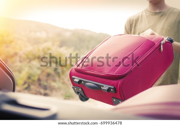 putting the
suitcase in the car, luggage and
travel