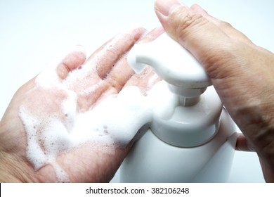 Putting Whip Foam Soap Bottle With Foam On Female Hand.