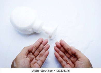Putting whip foam soap bottle with foam and hands on blue-gray background. - Shutterstock ID 429203146