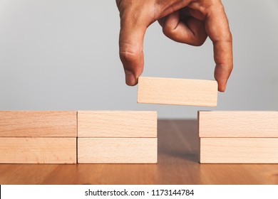 Putting a wooden block between gap, business concept