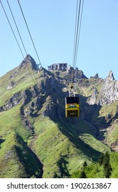 Puy De Sancy France Circa May 2019. Chair Lift With Cable Leading To The Top Of The Mountain. Green Slopes Jagged Summit. No People.