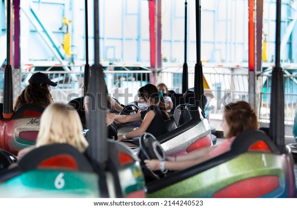 Puyallup, Washington, United States - 09-13-2021: A\
view of several people enjoying the bumper cars attraction, seen at\
the Washington State\
Fair.