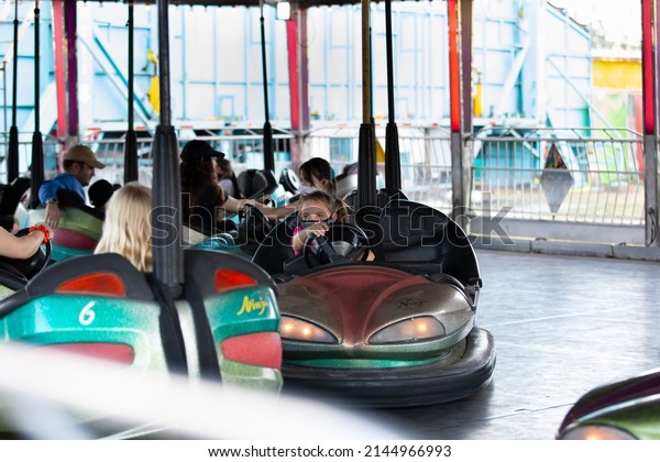 Puyallup, Washington, United States - 09-13-2021: A
view of several people enjoying the bumper cars attraction, seen at
the Washington State
Fair.