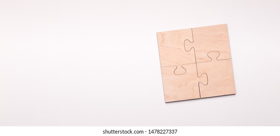 Puzzle of four wooden pieces with copy space for text, white background, panorama