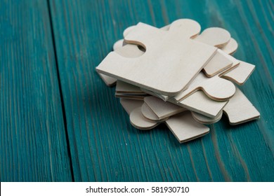 Puzzle pieces on a blue wooden background