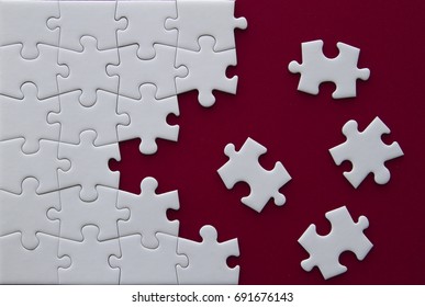 Puzzle pieces on red background.