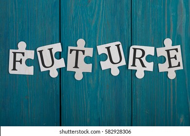 Puzzle pieces with word "Future" on blue wooden background