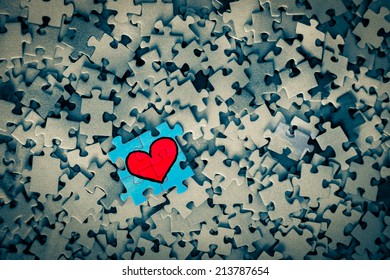 Puzzle red heart blue background