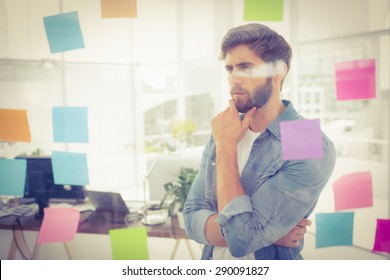 Puzzled Businessman Looking Post Its On The Wall In The Office