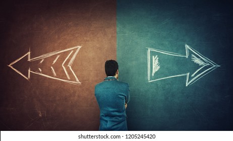 Puzzled businessman and a split blackboard with arrows going in two different ways red and blue side. Correct choice between left and right, failure or success. Difficult decision and doubt concept. - Powered by Shutterstock