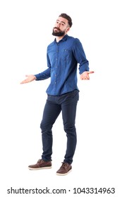 Puzzled Confused Man In Blue Shirt Shrugging Shoulders Looking At Camera. Full Body Isolated On White Background.