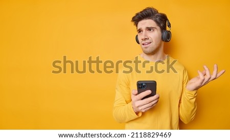 Similar – Image, Stock Photo A handsome man with green eyes with a vegetation background