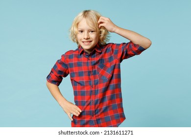 Puzzled Little Curly Kid Boy 10s Years Old Wearing Basic Red Checkered Shirt Put Hand On Head Looking Camera Isolated On Blue Color Background Children Studio Portrait. Childhood Lifestyle Concept