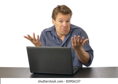 Puzzled Man At Computer Shrugs Shoulders And Expresses Lack Of Knowledge