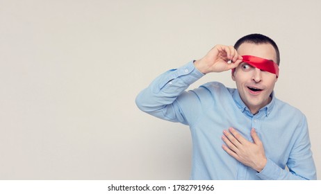 Puzzled Person Removes Blindfold, Portrait, White Background, Copy Space, 16:9