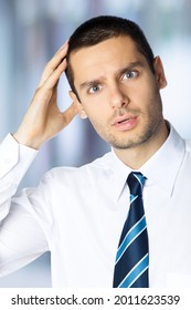 Puzzled, Shocked Panic Young Brunette Businessman In White Shirt And Tie, Indoors. Confident Business Man. Male  Executive Employee Person. Bank Manager At Office.