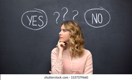 Puzzled Woman Choosing Between Yes No, Stereotype Of Uncertain Female Thinking