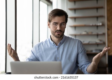 Puzzled Worried Businessman Concerned About Problems With Laptop. Angry User Staring At Computer Screen, Getting Bad News, Surprise, Feeling Stress About Software, App Or Services Errors