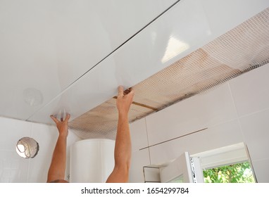 PVC Ceiling Panels, Cladding Installation. Builder Installing, Renovate, Repair White PVC Ceiling Boards In The Bathroom