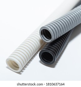 PVC flexible electrical conduit isolated on white background. Plastic curvilinear hoses. Colored corrugated pipe for installation of electrical cable