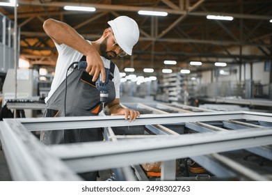 PVC industry worker or operator making frames for windows and doors. - Powered by Shutterstock