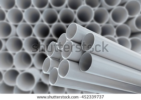 PVC pipes stacked in warehouse.