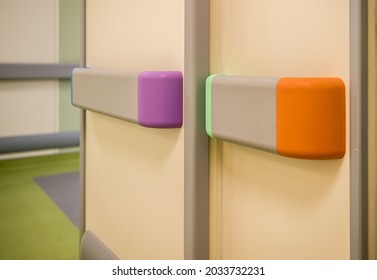 PVC Wall Protection In Children's Hospital. Closed Up Handrail Detail In Corridor For Kids Or Disabled People. Colorful Rubber, Baby Furniture Sharp Corner Protection In School And Kindergarten.