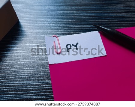 PY writting on table background. 