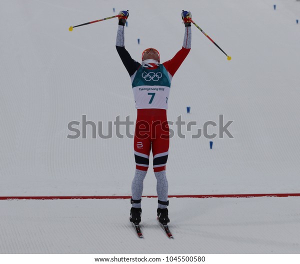PYEONGCHANG, SOUTH KOREA - FEBRUARY 11, 2018:\
Olympic Champion   Simen Hegstad Krueger of Norway at finish line\
at mass start in the Men\'s 15km + 15km Skiathlon at the 2018 Winter\
Olympic Games