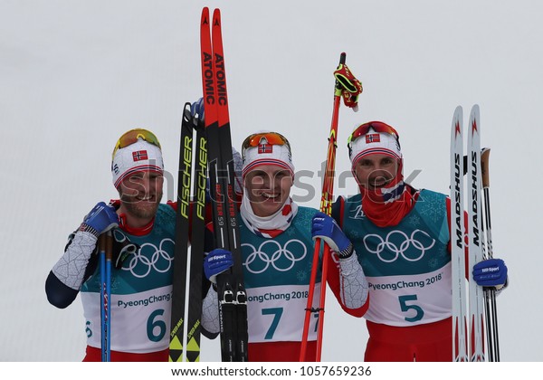PYEONGCHANG, SOUTH KOREA - FEBRUARY 11, 2018: M\
J Sundby (L),  S H Krueger and H C Holund all of Norway celebrate\
victory at  mass start in the Men\'s 15km + 15km Skiathlon at the\
2018 Winter\
Olympics