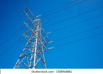 Pylon and High Voltage Powerline with a Background Blue Sky
