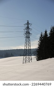 A pylon used to support overhead power lines. Pylons are designed to withstand wind, weather, and other environmental factors to ensure the safe and reliable transmission of electricity or communicati