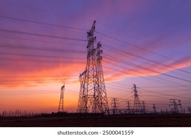 The pylons are in the evening, Substation in the evening, the silhouette of the power supply facilities, High voltage substation and beautiful sunset glow