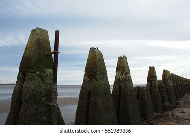 Pylons leading to the Cramond Island at low tide in Scotland